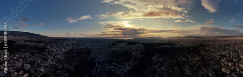 Aerial drone panoramic photo of beautiful sunset with golden colours and clouds over iconic Acropolis hill and Masterpice of Western ancient civilisation - the Parthenon, Athens, Attica, Greece © aerial-drone