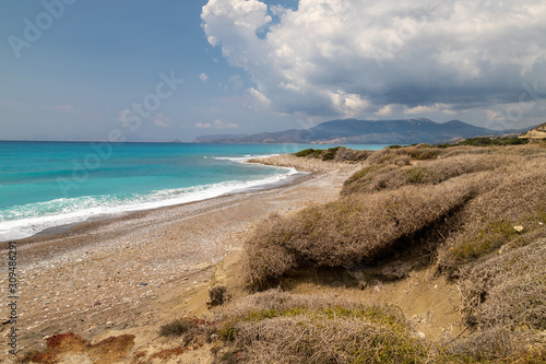 Gravel / pebble beach at the westcoast of Rhodes island near Kattavia with ocean waves photo