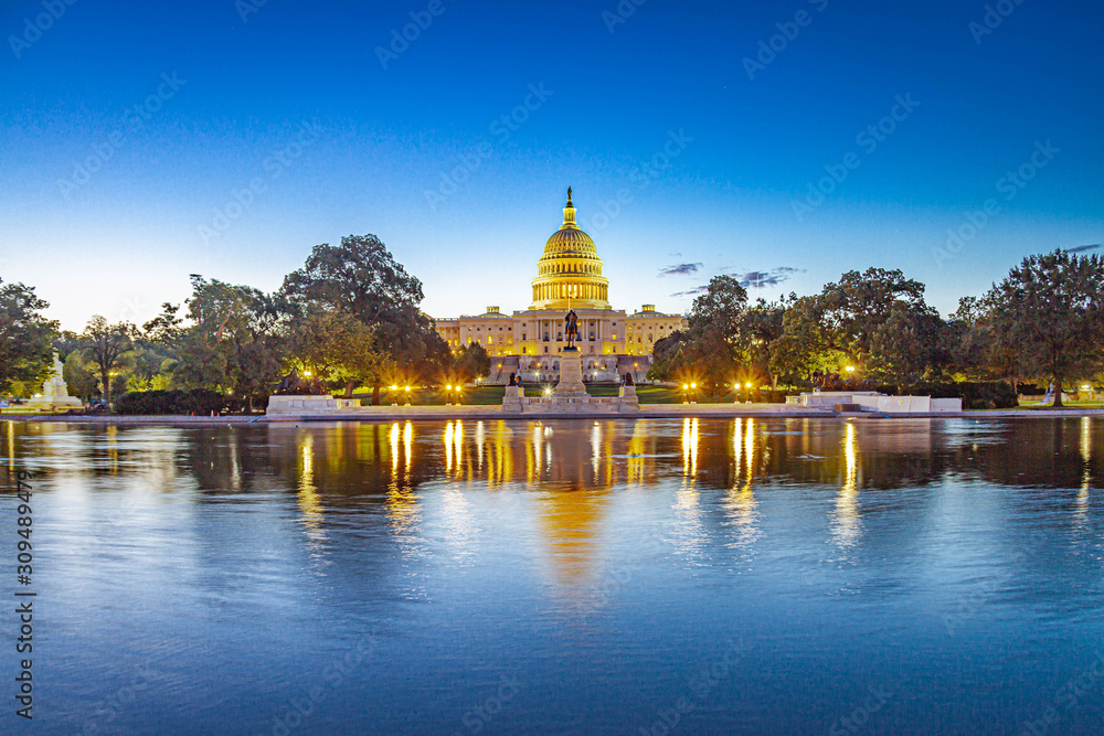 The Capitol of the United States with the capitol reflecting pool in morning light.
