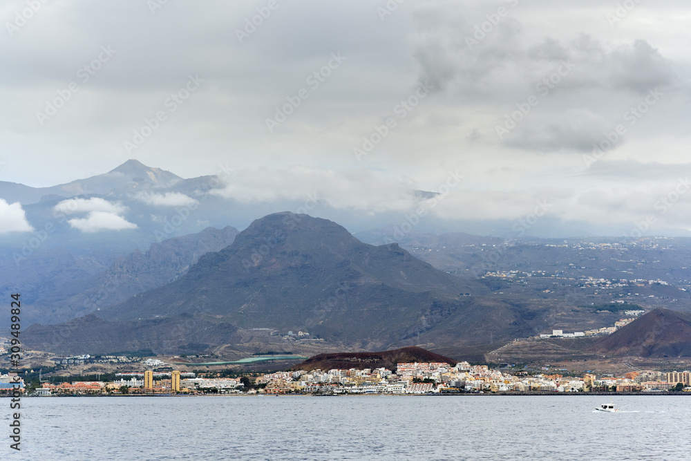 Los Cristianos waterside distant view spanish resort town in Spain south coast of the Canary Island of Tenerife and view of Mount Teide
