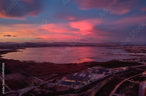 Bright cloudy sky purple violet pink colors sunset over Torrevieja salt lake Las Salinas view from above  aerial photography picturesque landscape  Province of Alicante  Costa Blanca  Spain. Europe