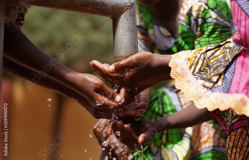 Hands under Tap from African Black Children with Fresh Clean Water photo