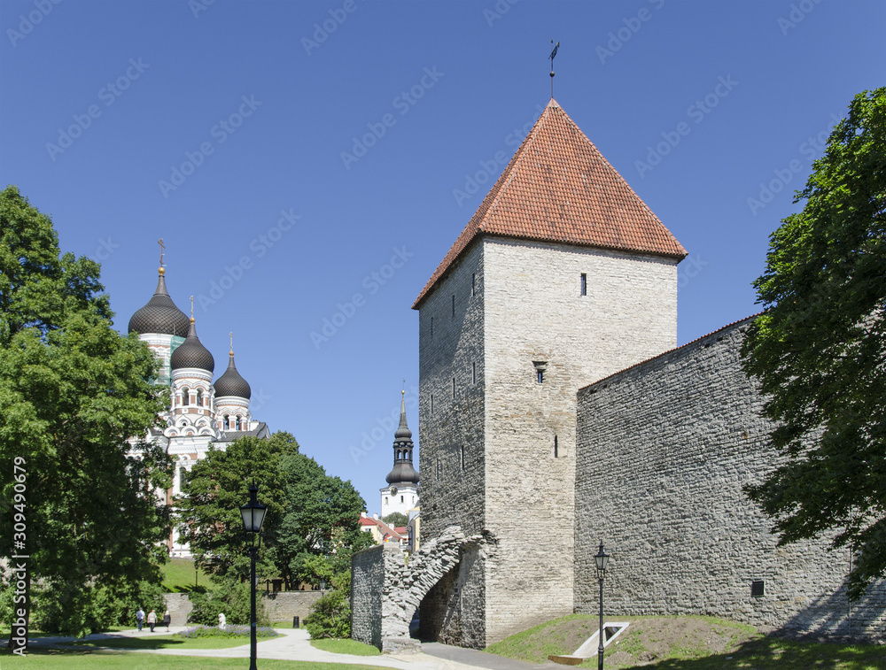 The old city in Tallinn in summer, the old high brick tower and the Orthodox church are visible