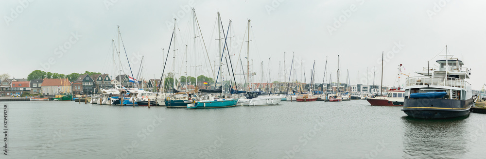 Panorama of the port town of Urk, view from the breakwater on moored boats.
