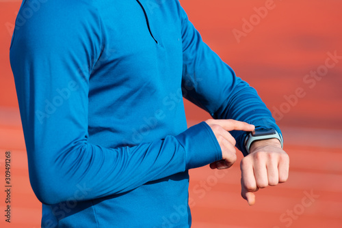 Successfully Runner Looking At Heart Rate Monitor Smart Watch, close up .