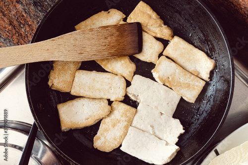 Tofu stir-fried in a black pan