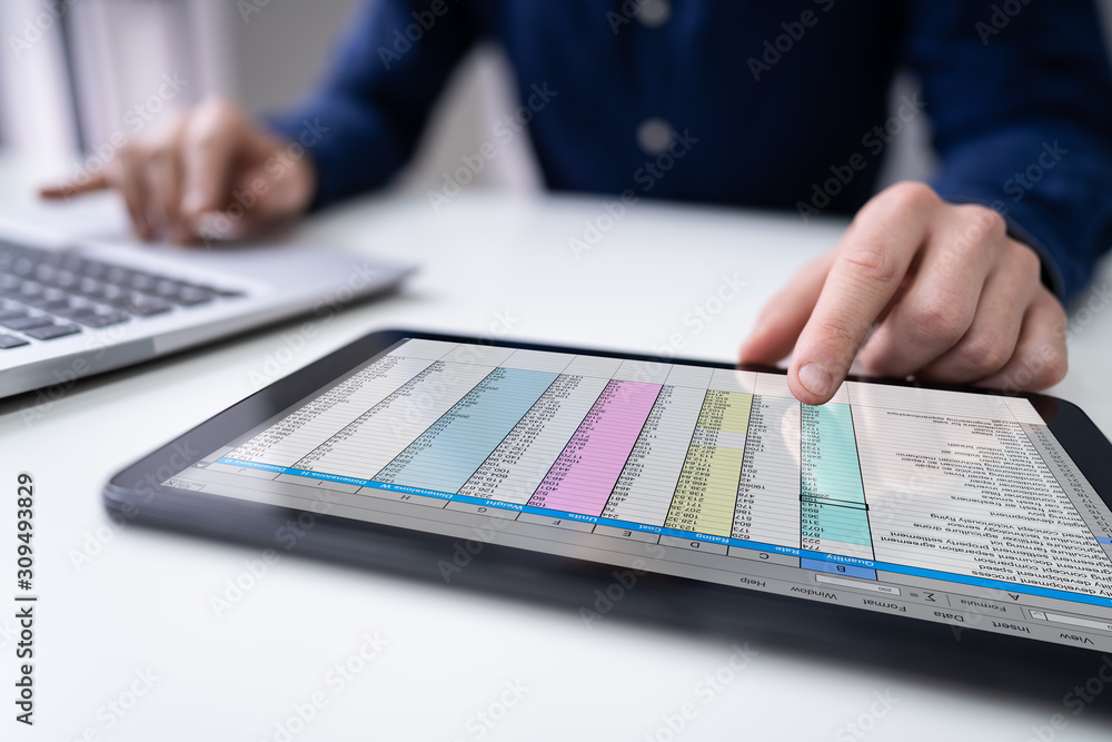 Businessman Analyzing Data On Tablet Businessman Analyzing Data On Tablet