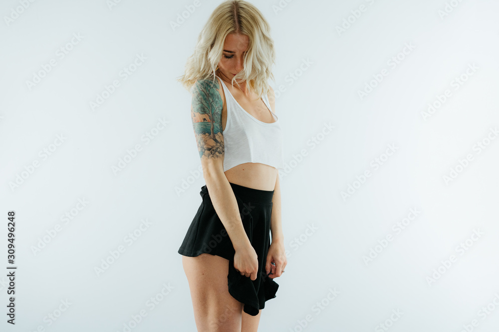 Young blonde sexy woman in mini skirt and crop top exposing booty Stock  Photo | Adobe Stock