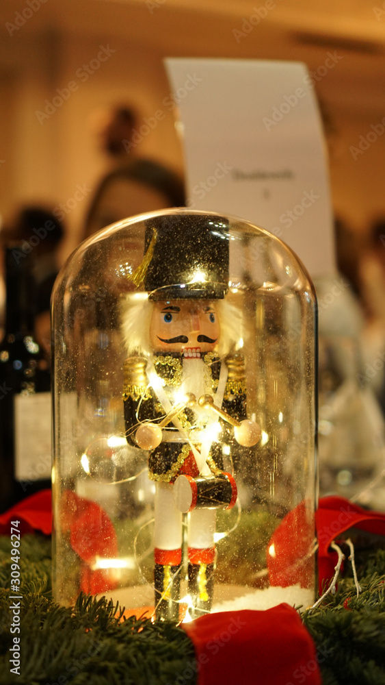 Nutcracker soldier toy in a glass on a Christmas decorated table in London, United Kingdom.
