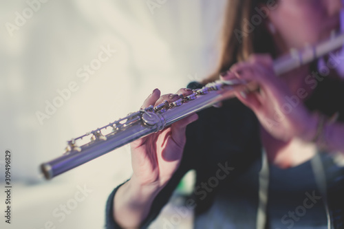 Fotografija Concert view of a flutist flute player with musical jazz band and audience in th