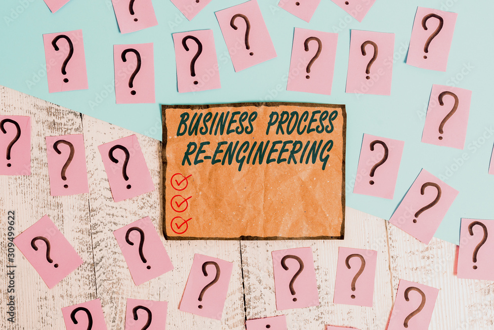 Writing note showing Business Process Re Engineering. Business concept for the analysis and design of workflows Scribbled and crumbling papers with thick cardboard above wooden table Writing note showing Business Process Re Engineering. Business concept for the analysis and design of workflows Scribbled and crumbling papers with thick cardboard above wooden table