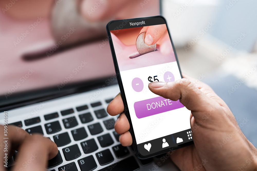 Man Donating Money On Mobile Phone Man Donating Money On Mobile Phone