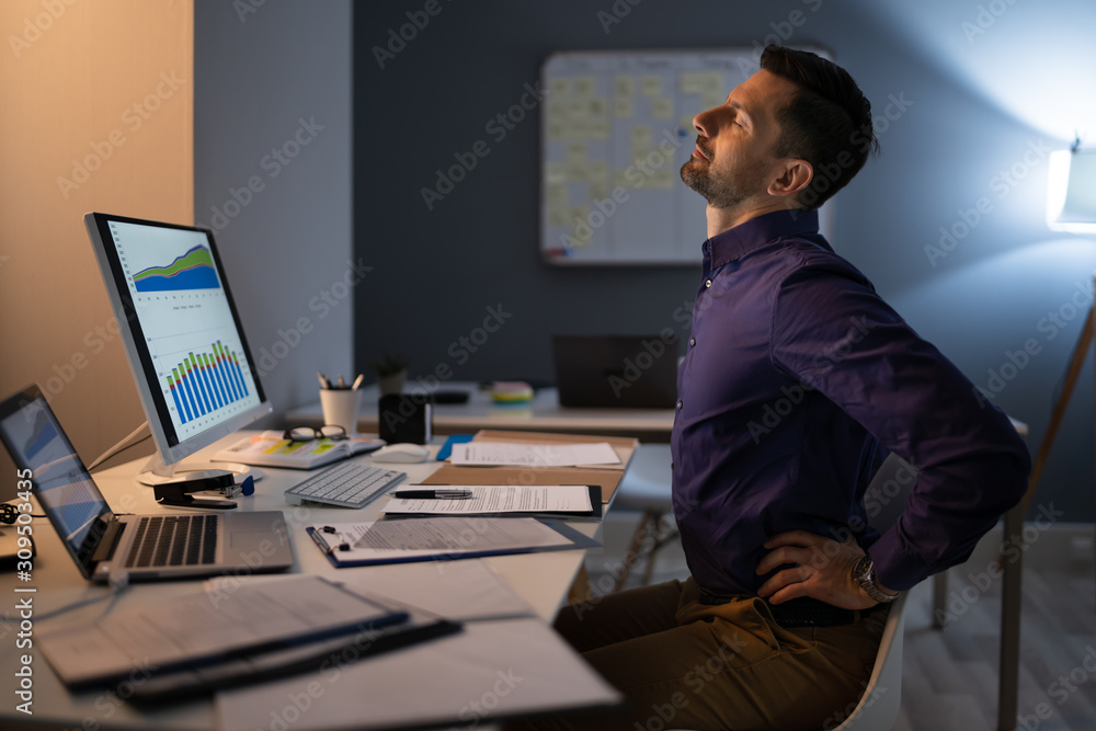Businessman Having Backache At Work Businessman Having Backache At Work