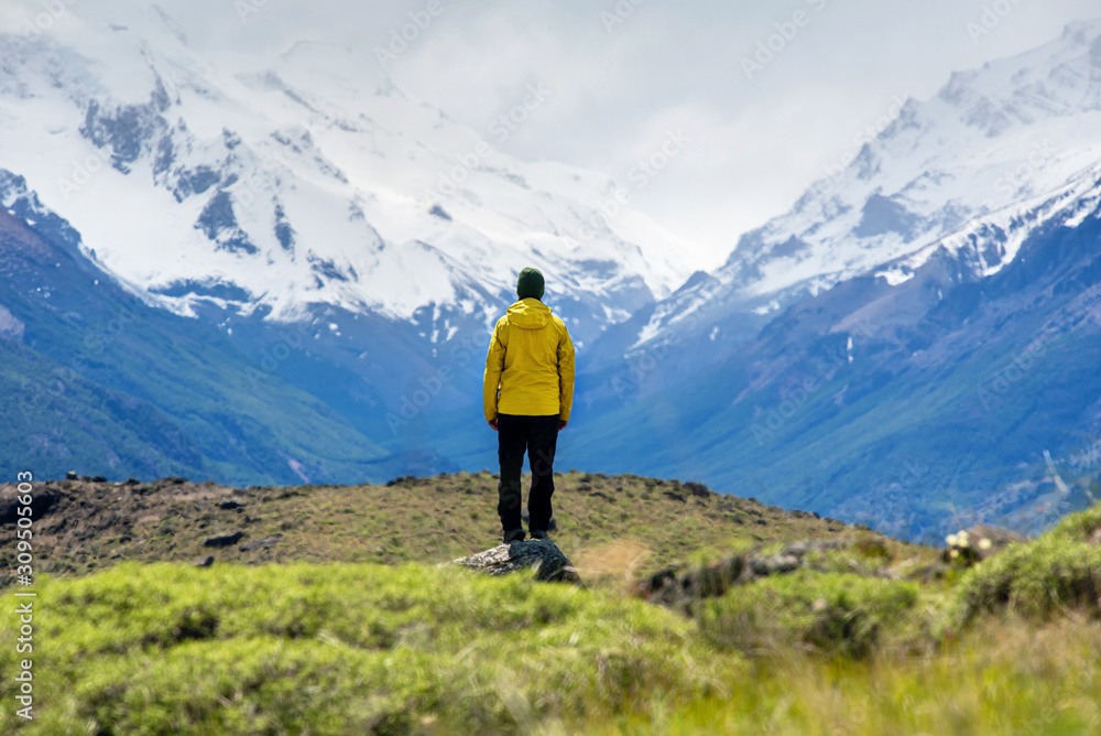 A hiker man looks over the mountains in El Chalten, Patagonia, Argentina
