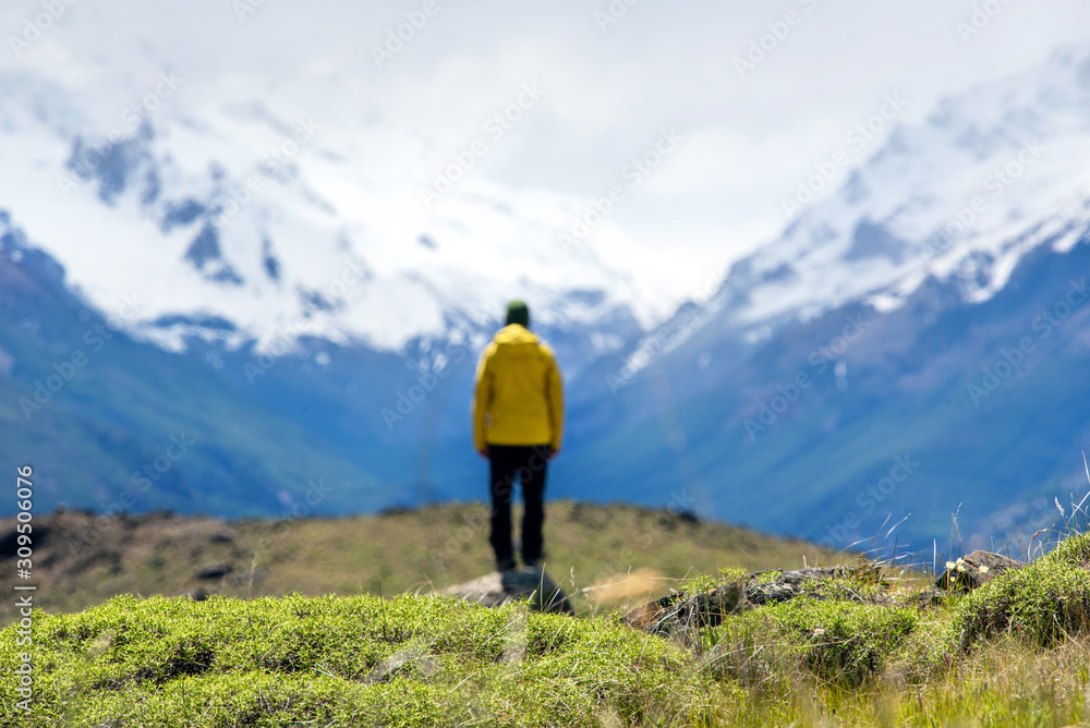 A hiker man looks over the mountains in El Chalten, Patagonia, Argentina A hiker man looks over the mountains in El Chalten, Patagonia, Argentina