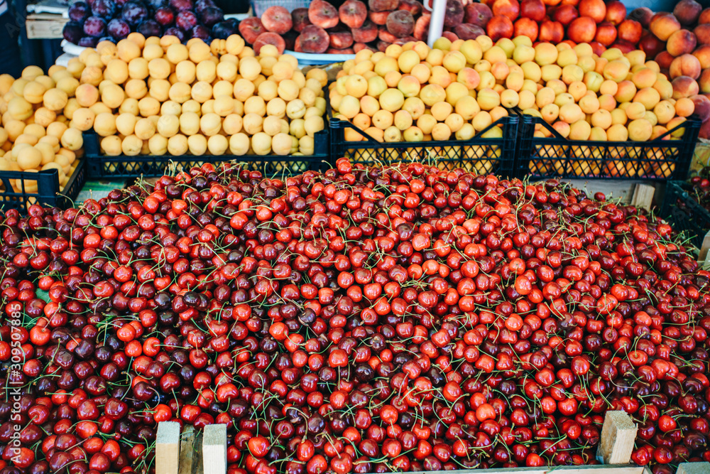 Fresh fruit in the market. Apricots, peaches, cherries, apples