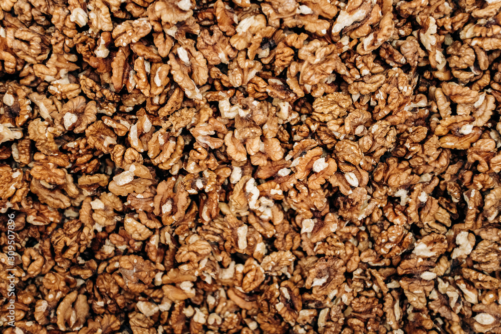Closeup of big shelled walnuts pile. The background of their shelled walnuts. Closeup of big shelled walnuts pile. The background of their shelled walnuts.