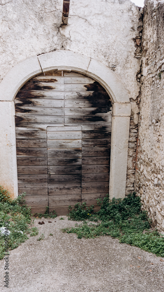 Fototapeta premium Arched medieval door with clipping path. Beautiful antique door
