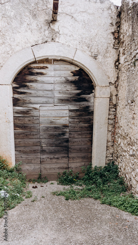 Arched medieval door with clipping path. Beautiful antique door © EwaStudio