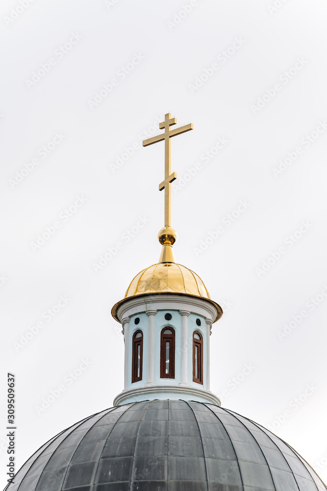 Golden cross of the Christian temple. Top of Orthodox church building