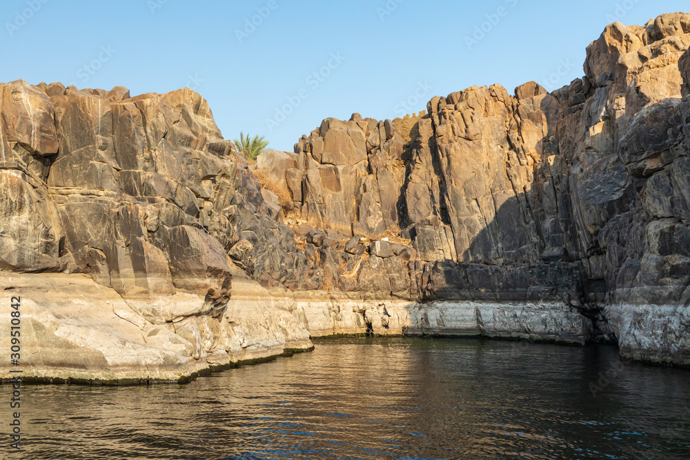Rock cliffs along the banks of the Nile river in Aswan