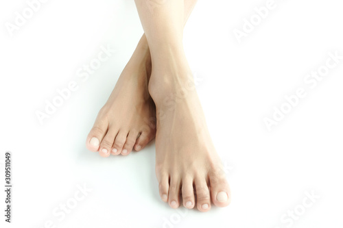 Fototapeta Naklejka Na Ścianę i Meble -  Beautiful female legs and feet on a white background.Concept beauty and hydration of the skin.