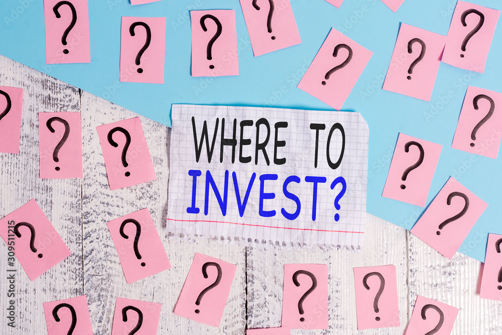 Conceptual hand writing showing Where To Invest Question. Concept meaning asking about where put money into financial schemes or shares Crumbling papers with thick cardboard on the wooden table Conceptual hand writing showing Where To Invest Question. Concept meaning asking about where put money into financial schemes or shares Crumbling papers with thick cardboard on the wooden table