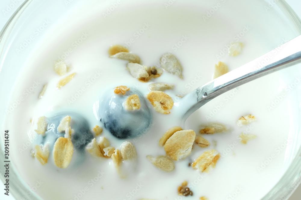 Fototapeta premium Healthy food, yoghurt, berry fruit and cereal in a spoon