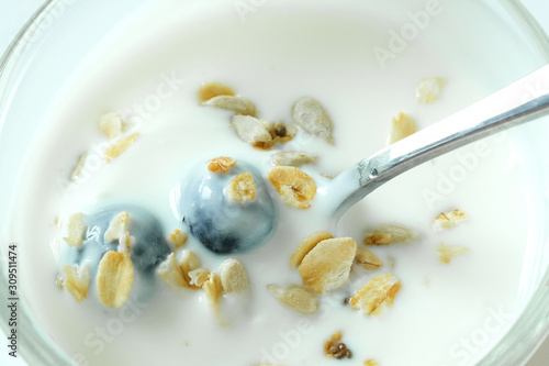 Healthy food  yoghurt  berry fruit and cereal in a spoon