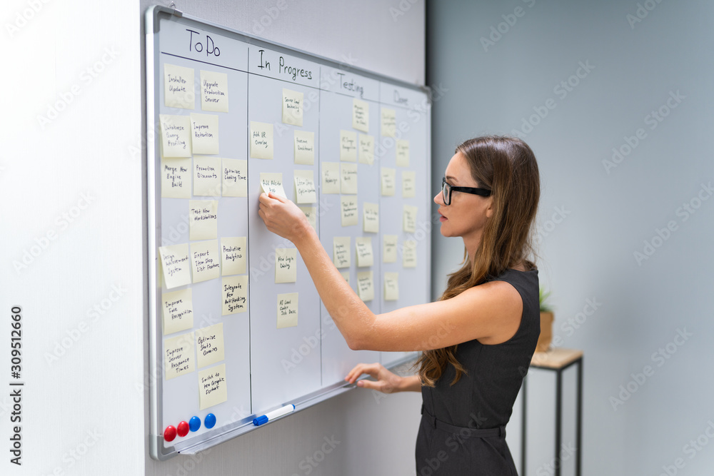 Businesswoman Arranging Sticky Notes Businesswoman Arranging Sticky Notes