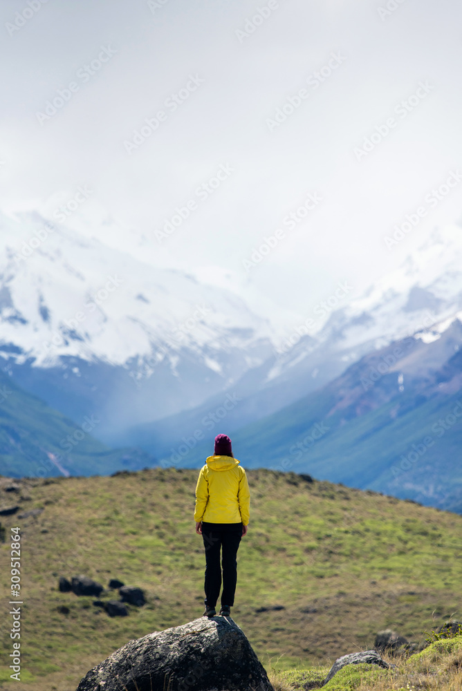A hiker woman looks over the mountains in El Chalten, Patagonia, Argentina