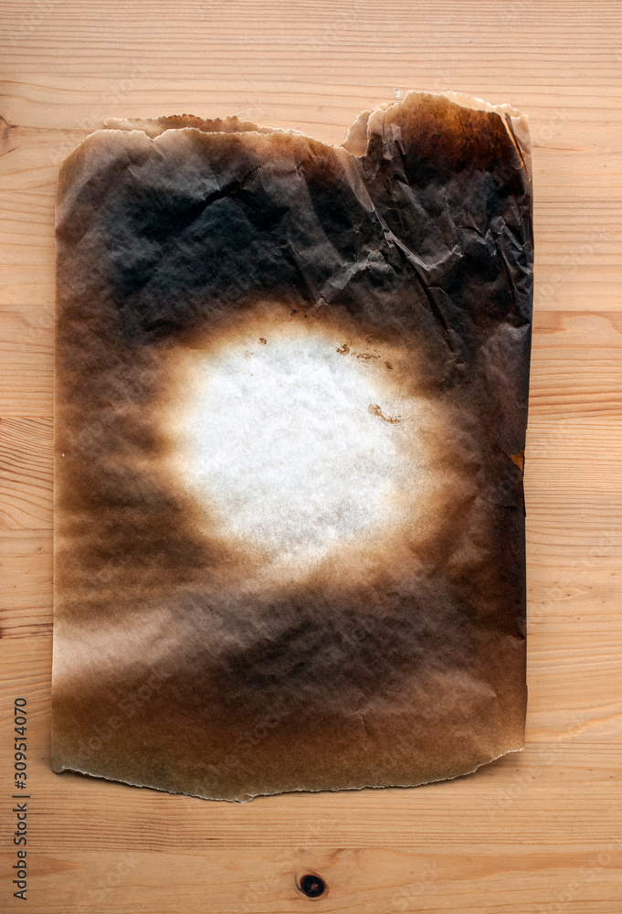 Burning the dinner - a sheet of baking paper burnt in the oven