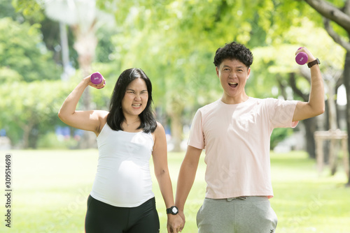 pregnant woman and man are doing breathing exercise together