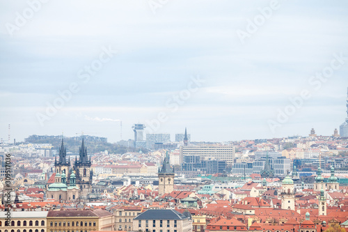 Panorama of Prague  Czech Republic  seen from the top of the castle  during an autumn cloudy afternoon. Major tourist landmarks such as medieval towers  cathedrals and churches  are visible