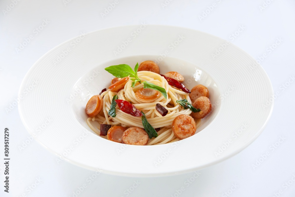 Smoked pork sausage sliced with stir-fried spaghetti topping with sweet basil leaves on white background.
P Smoked pork sausage sliced with stir-fried spaghetti topping with sweet basil leaves on white background.
P