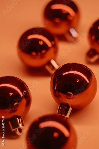 Red Christmas balls on pink background. Lush lava color. New Year decoration. 