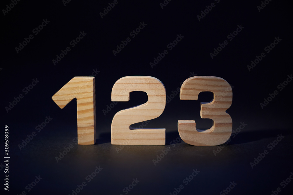 wooden numbers 123 on a black background wooden numbers 123 on a black background