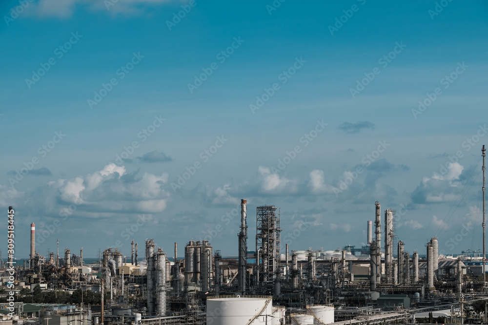 Gas distillation tower and smoke stack of Petroleum industrial plant on blue sky background, Downstream of fossil petroleum plant