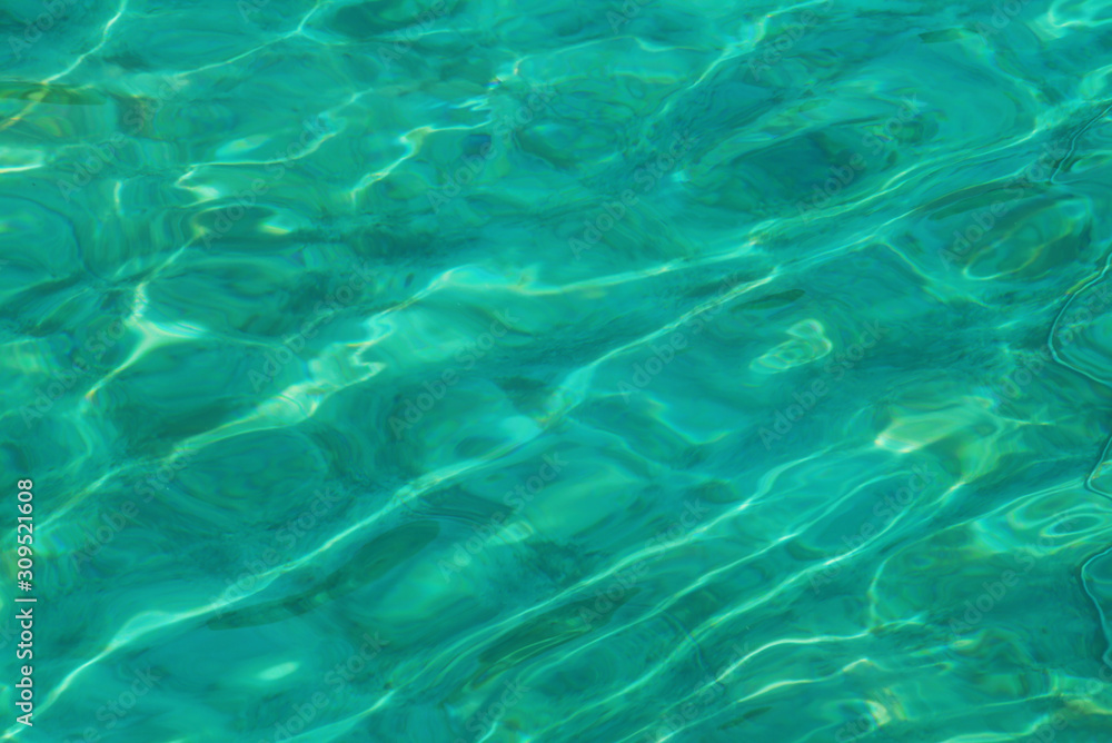 Surface of swimming pool, green water reflection.