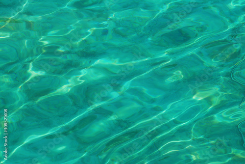 Surface of swimming pool, green water reflection.