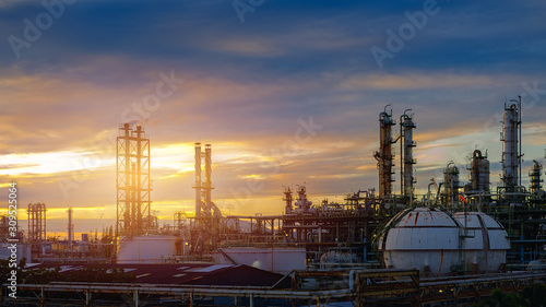 Manufacturing of petroleum industrial plant on sunset sky background