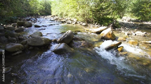4K landscape. Beauty of nature. Mountain river, stream flow  and stones.