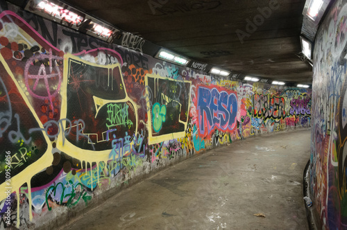 Graffiti covered walls of an underground pedestrian walkway in Belfast, Northern Ireland. © PhyllisPhotos