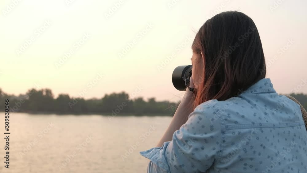 Asian woman take a photo with her camera. Asian woman take a photo with her camera.