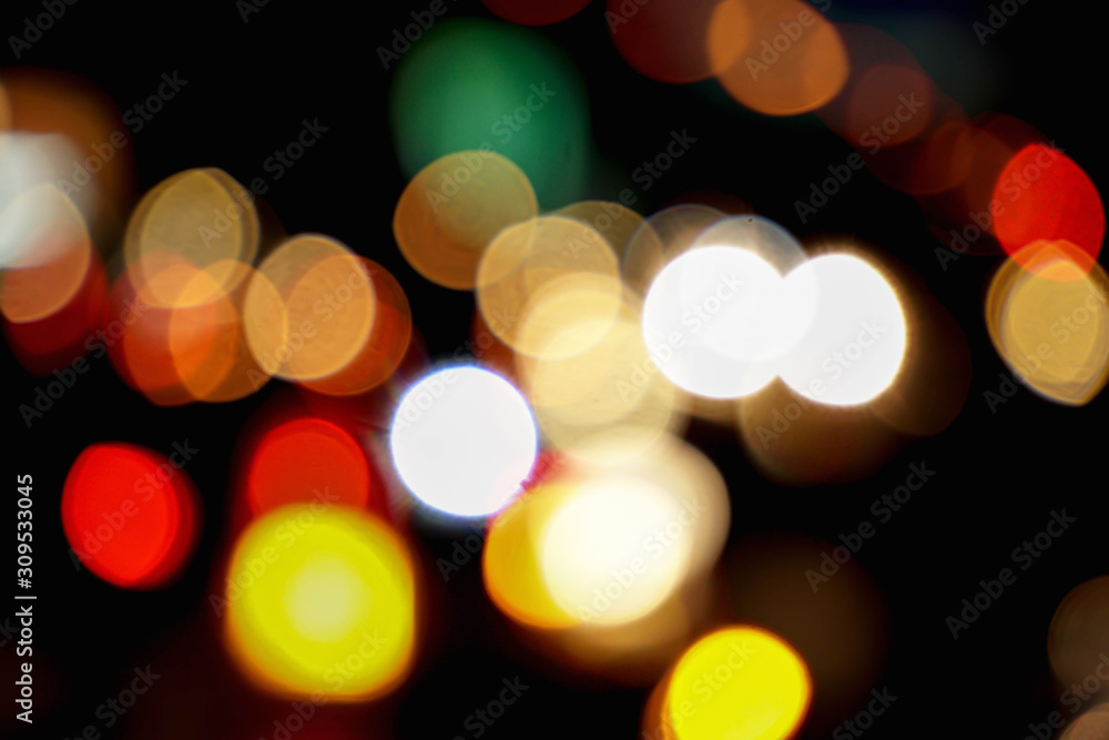 Abstract colorful bokeh reflection lighting on the road and black background.