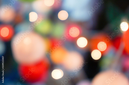 Blurred and bokeh reflection lighting of lights decorating the Christmas tree around beautifully.