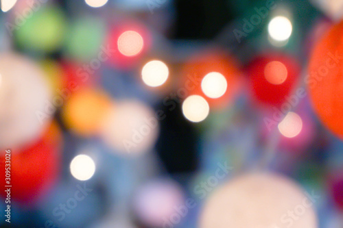 Blurred and bokeh reflection lighting of lights decorating the Christmas tree around beautifully.