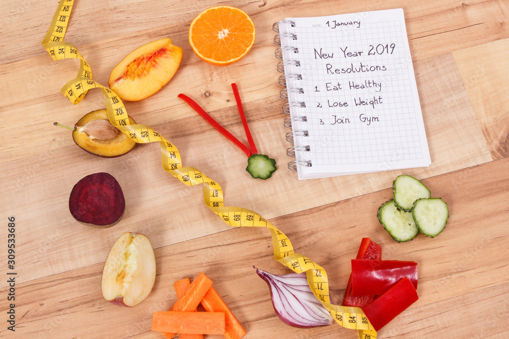 New year resolutions for 2019 and clock made of fruits with vegetables and tape measure