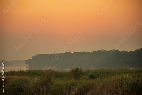 Scenic View Of Field Against Sky During Sunset © Sitthipong
