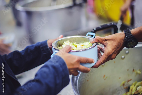 Homeless people receive free food from compassionate people: the concept of food needs